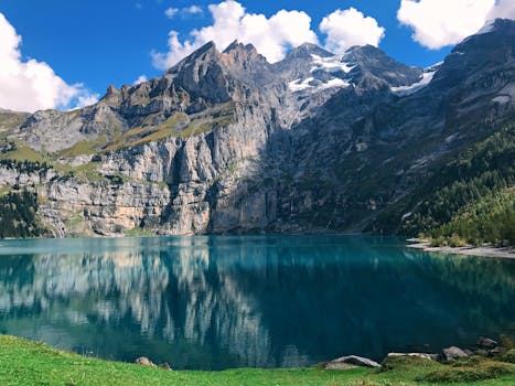 Stunning view of the Swiss Alps and a serene lake in Kandersteg, perfect for travel and nature enthusiasts.